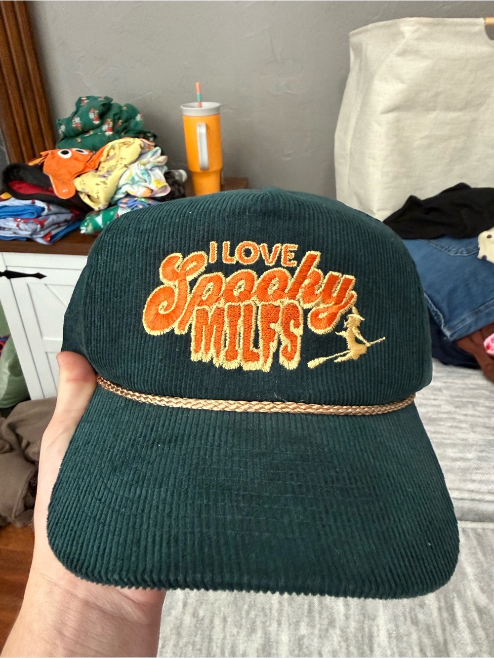Dark Green Corduroy Cap with Orange Embroidered Text and Gold Rope
